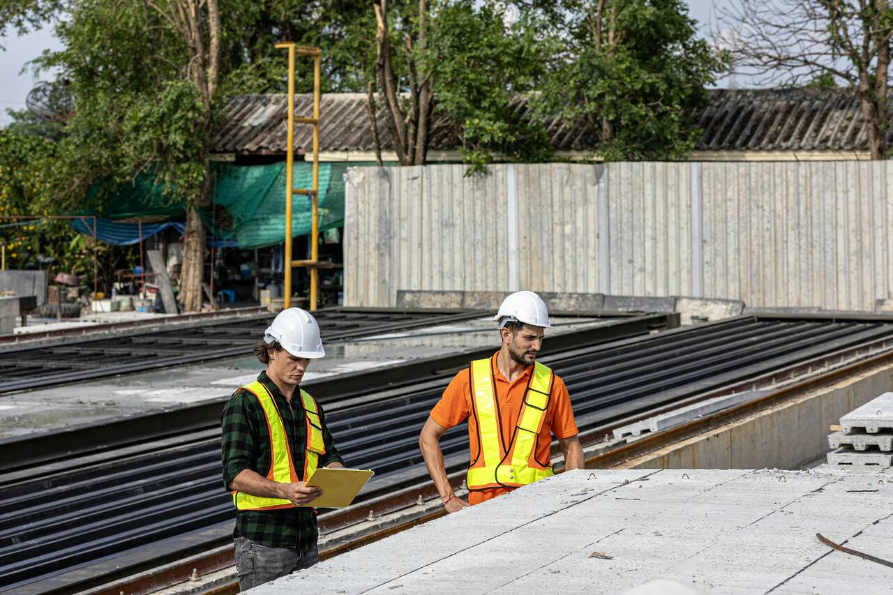 Construction engineers reviewing plans on site