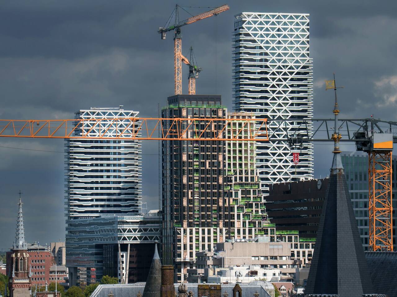 Modern towers under construction with cranes